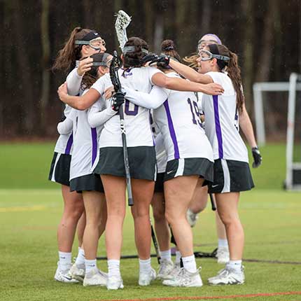 fields hockey students hugging