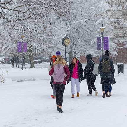 Students walking on campus in a snow