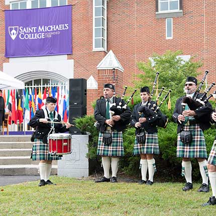 Scottish musicians in kilts playing bag pipes