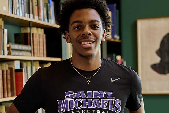 student with a Saint Michaels Basketball T shirt on