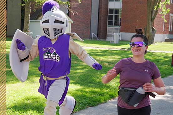 student and mascot jogging